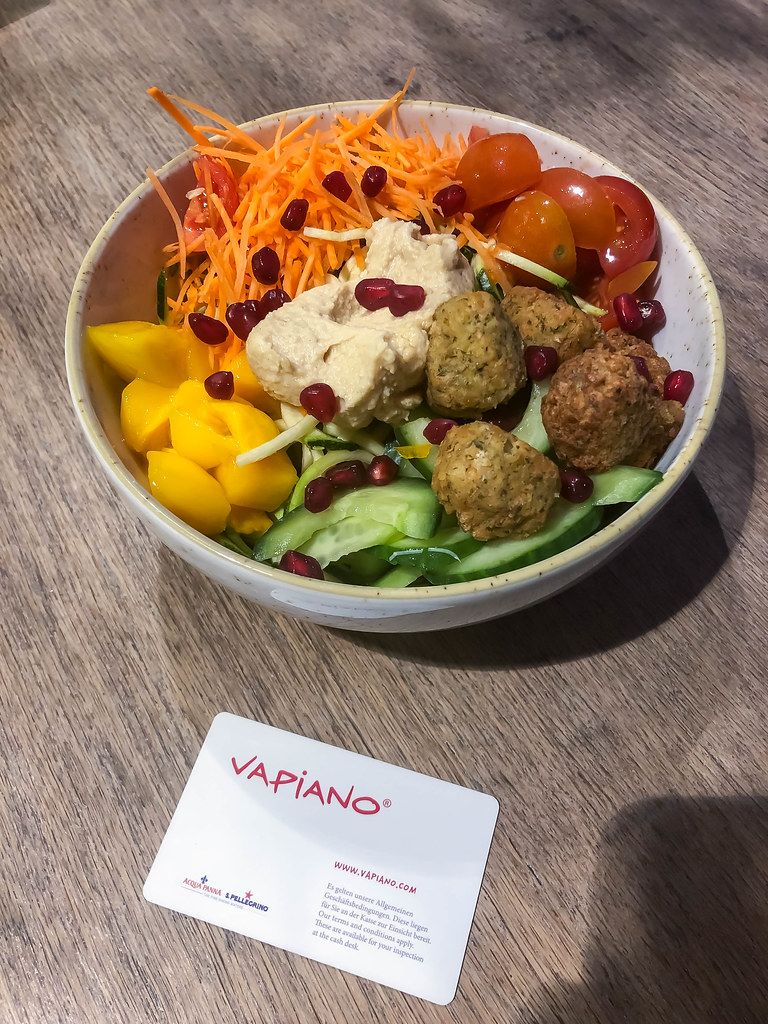 Vegan bowl at Vapiano with roman salad, falafel, hummus, mango, carrots, cherry tomatoes, cucumber and pomegranate seeds