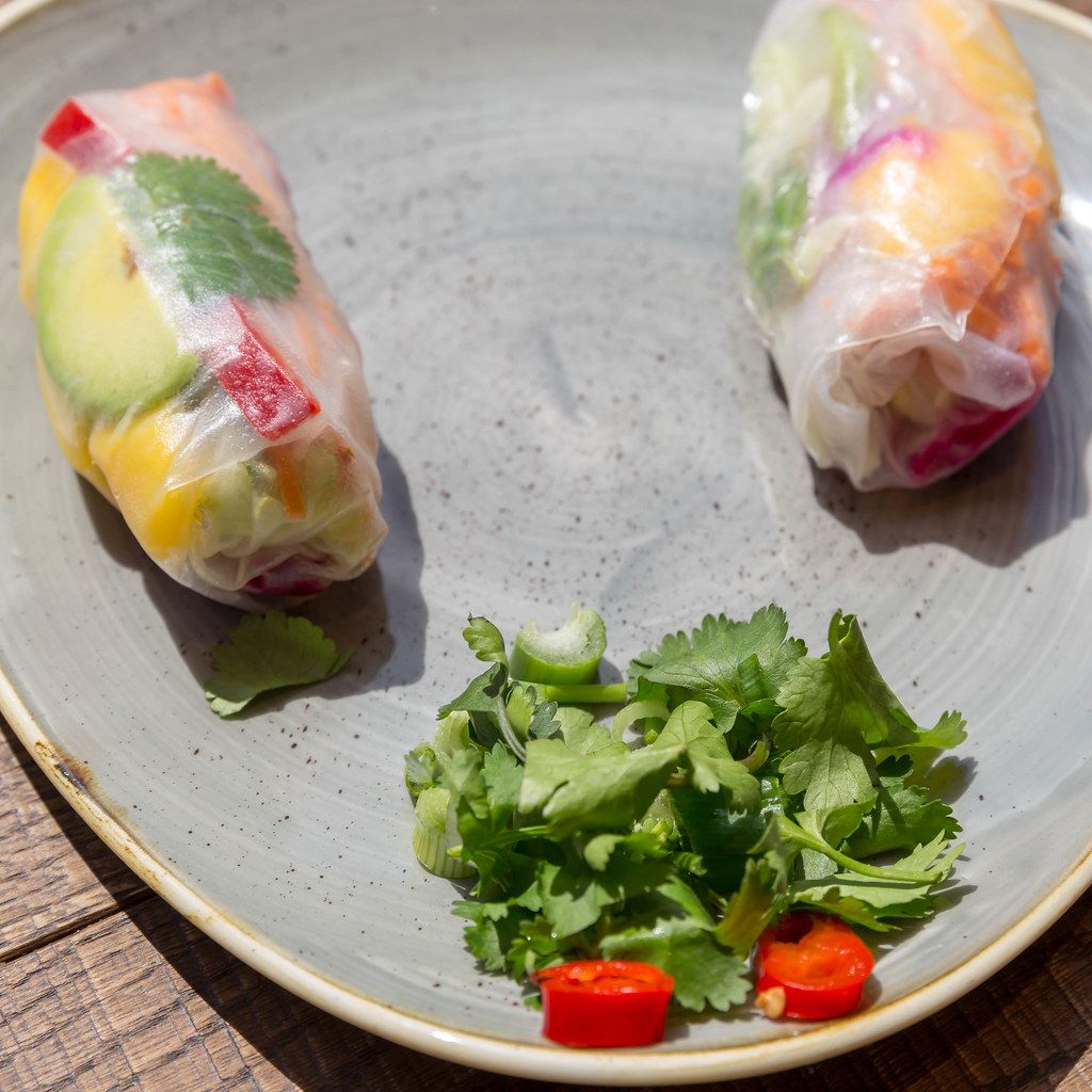 Vegan rainbow summer rolls with avocado, mango, peppers, red cabbage, cilantro, carrots, lettuce and rice noodles at Cologne`s coa Wok & Bowls restaurant