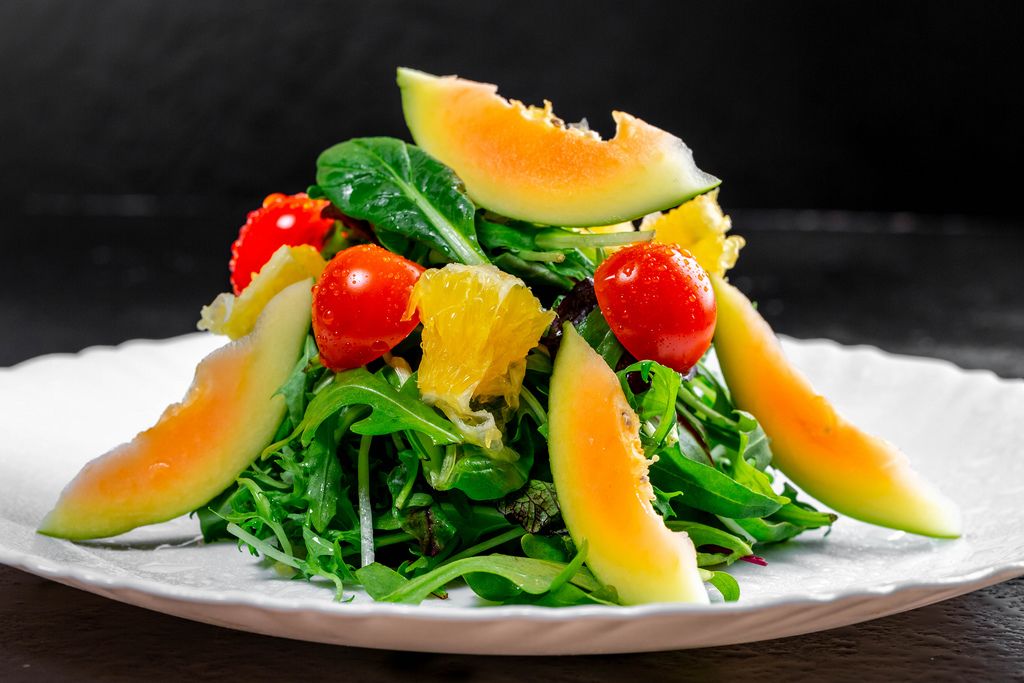 Vegetarian salad with herbs, tomatoes, avocado and orange (Flip 2019)
