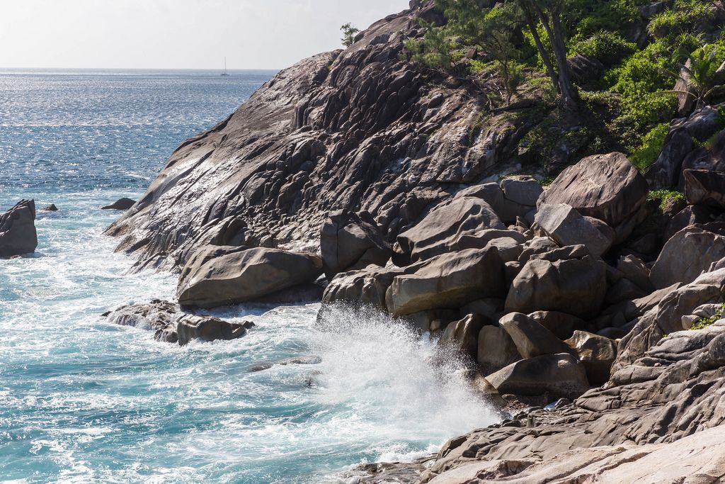 Waves at rocky coast of Seychelles island Mahé, near Anse des Anglais at Constance Ephelia Resort