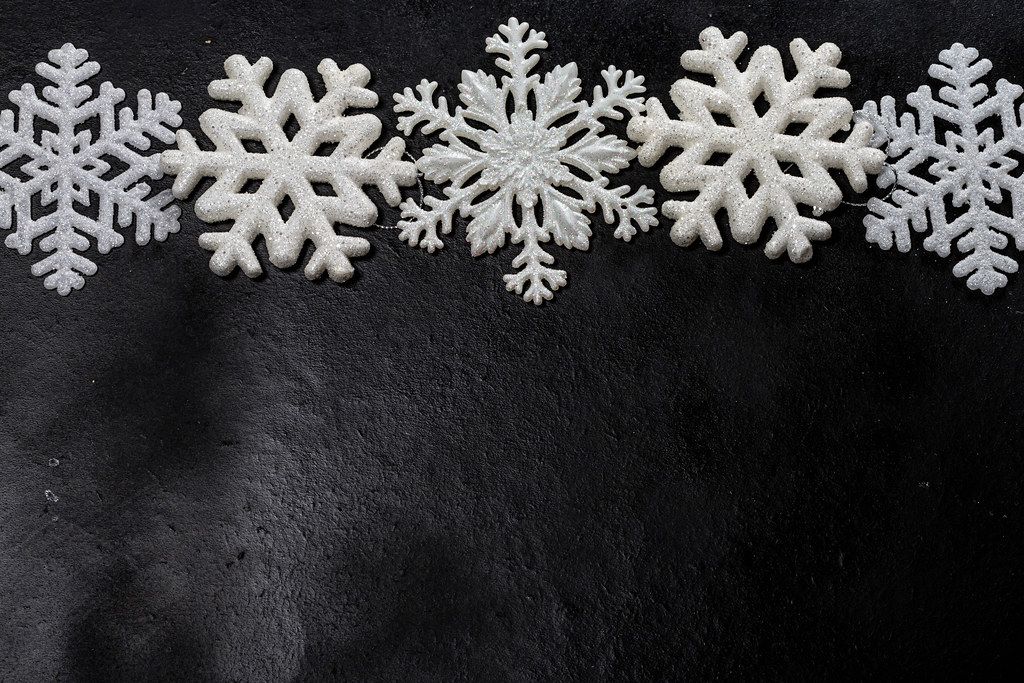White snowflakes on a black background. Free space (Flip 2019)
