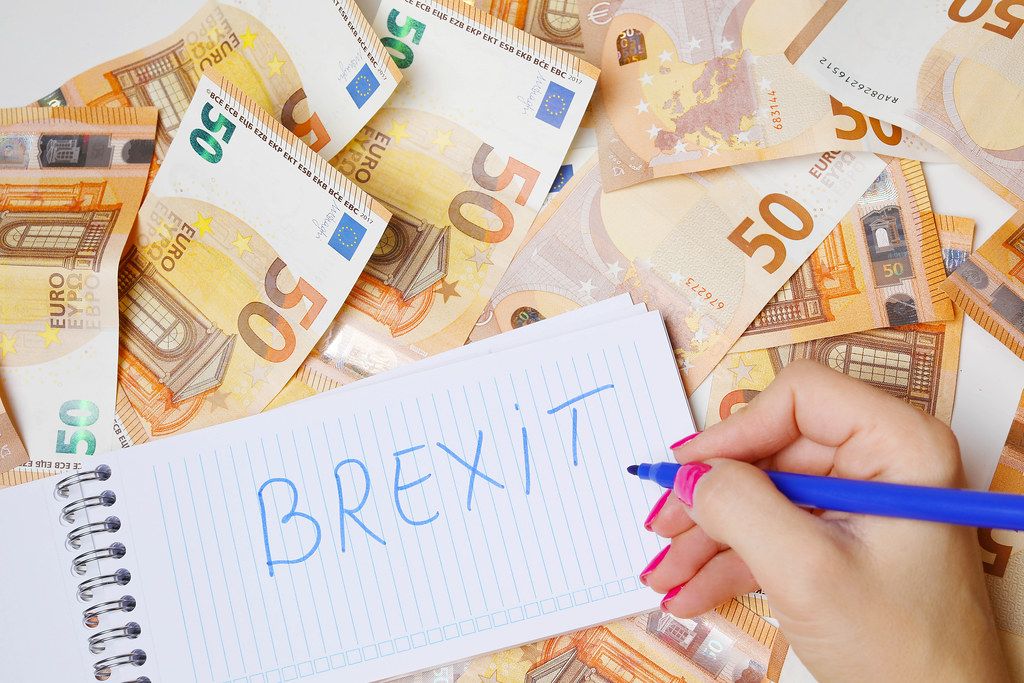 Woman hand writing Brexit, 50 Euro banknotes background
