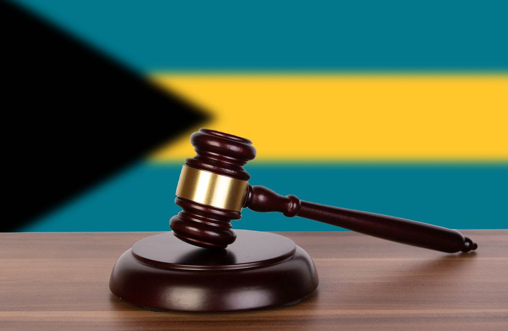 Wooden gavel and flag of Bahamas