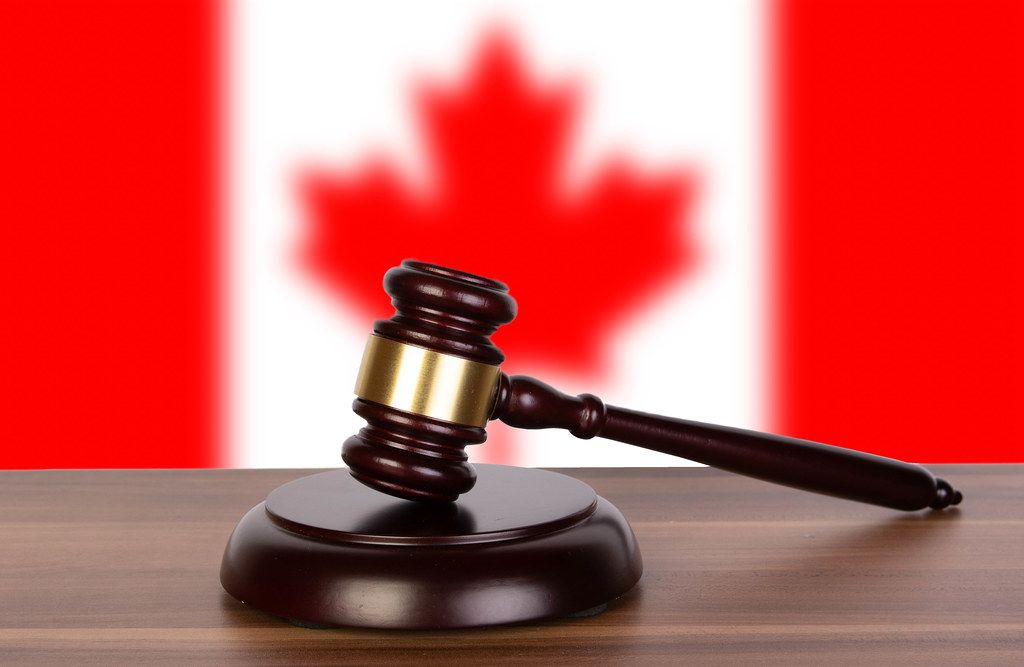 Wooden gavel and flag of Canada