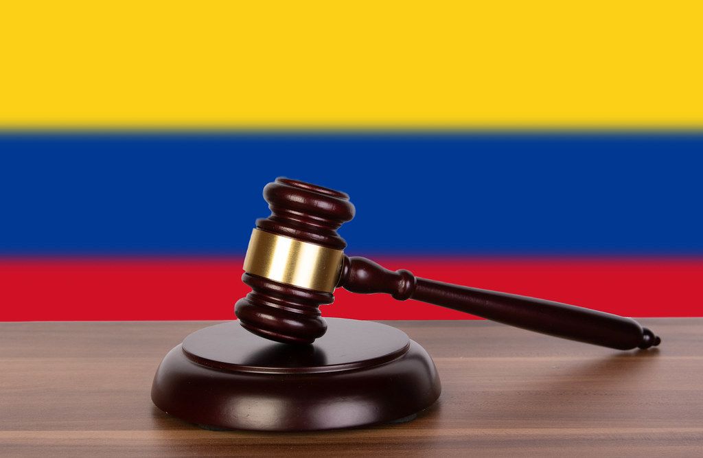 Wooden gavel and flag of Colombia
