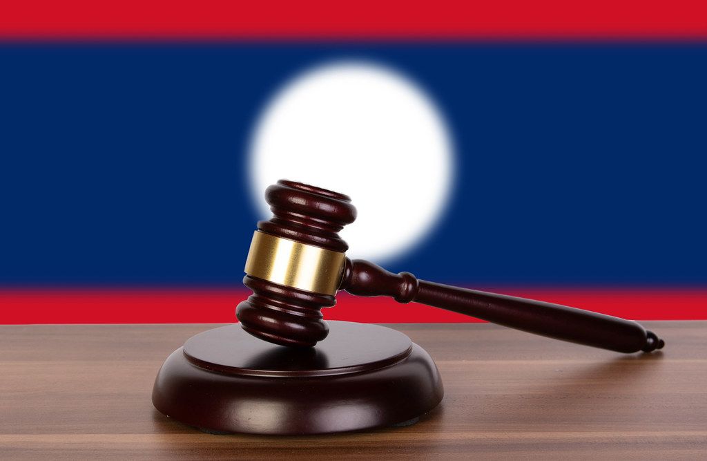 Wooden gavel and flag of Laos