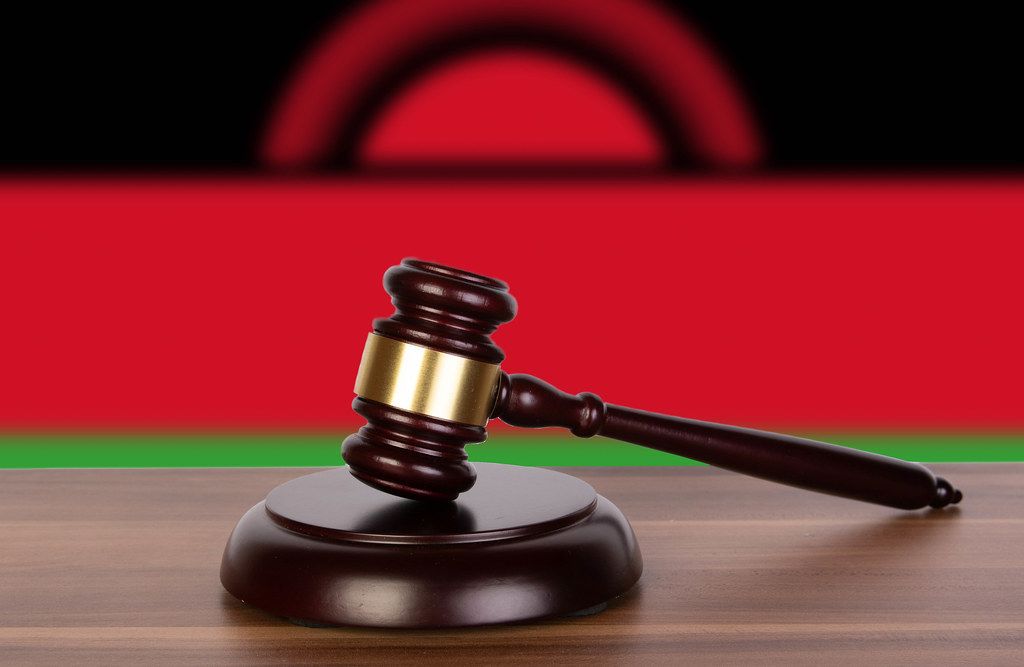 Wooden gavel and flag of Malawi
