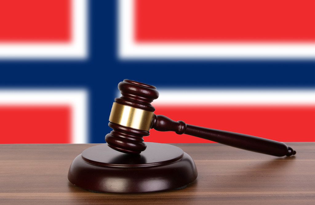 Wooden gavel and flag of Norway
