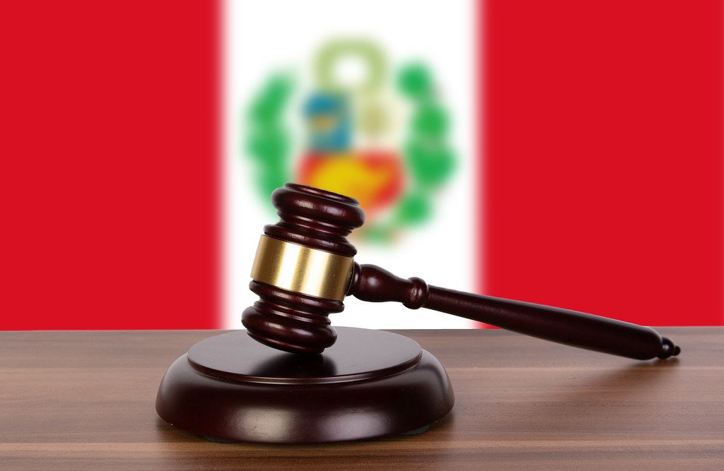 Wooden gavel and flag of Peru