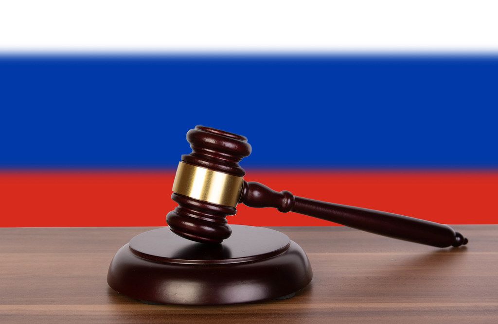 Wooden gavel and flag of Russia