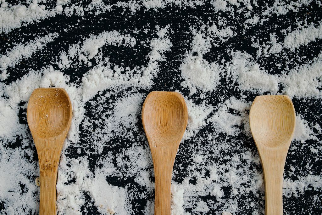 Wooden spoons with white flour