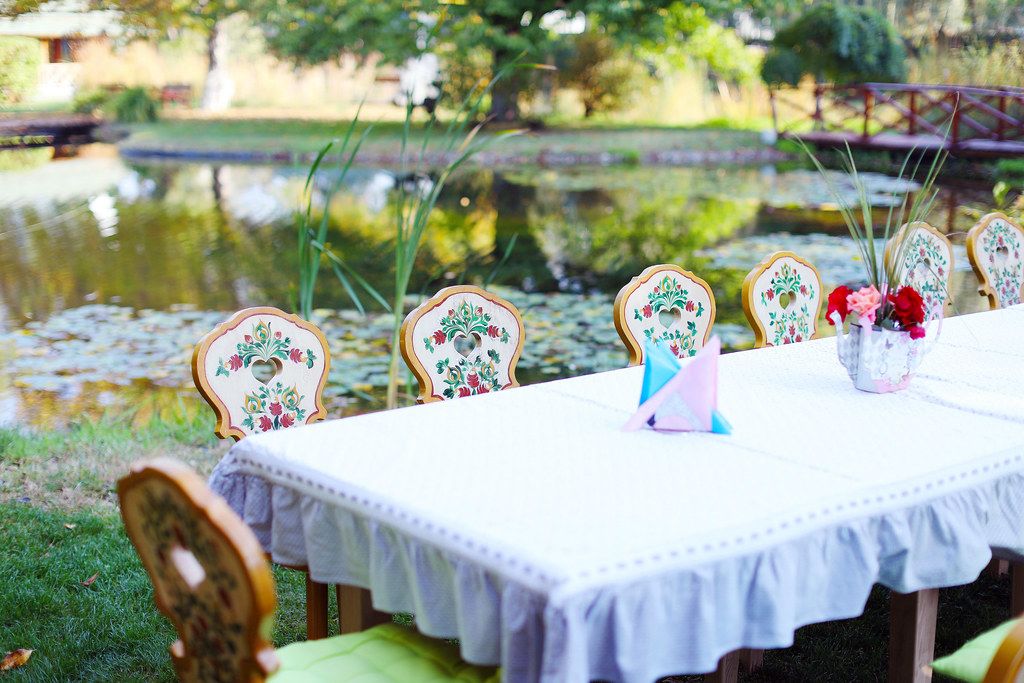 Wooden table and chairs ready for party, by the lake (Flip 2019)