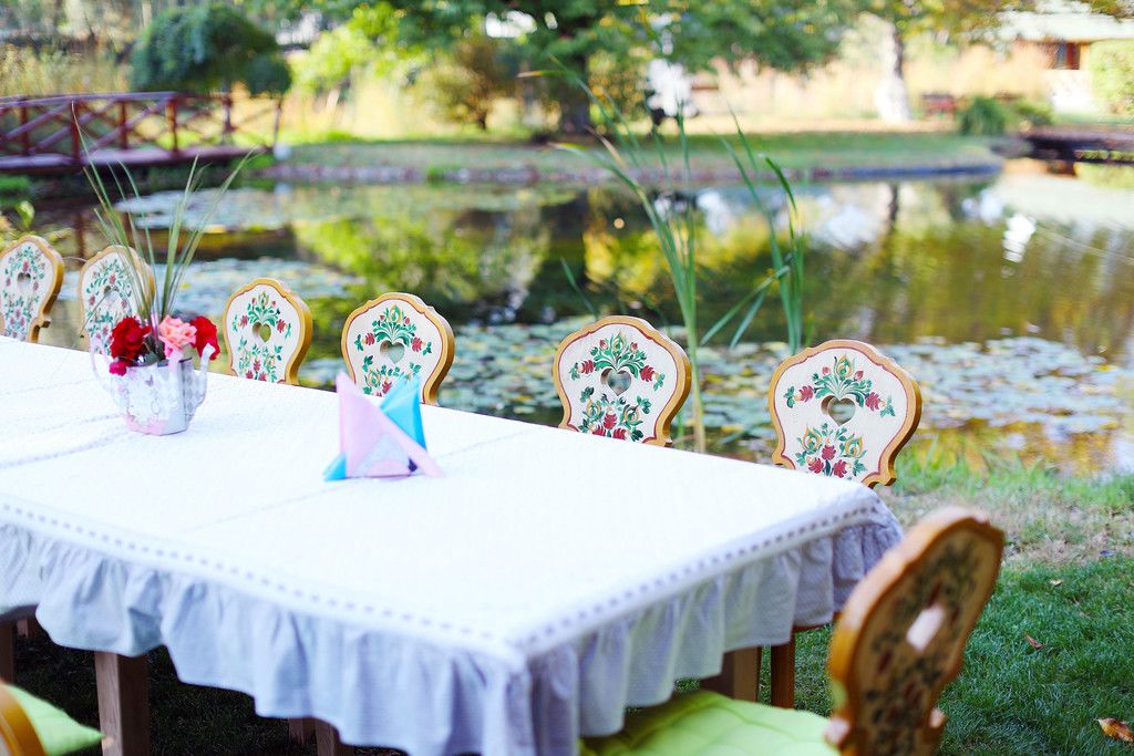Wooden table and chairs ready for party, by the lake