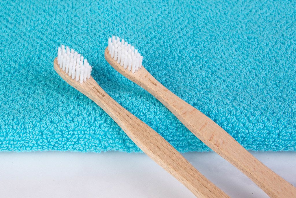 Wooden toothbrushes on towel