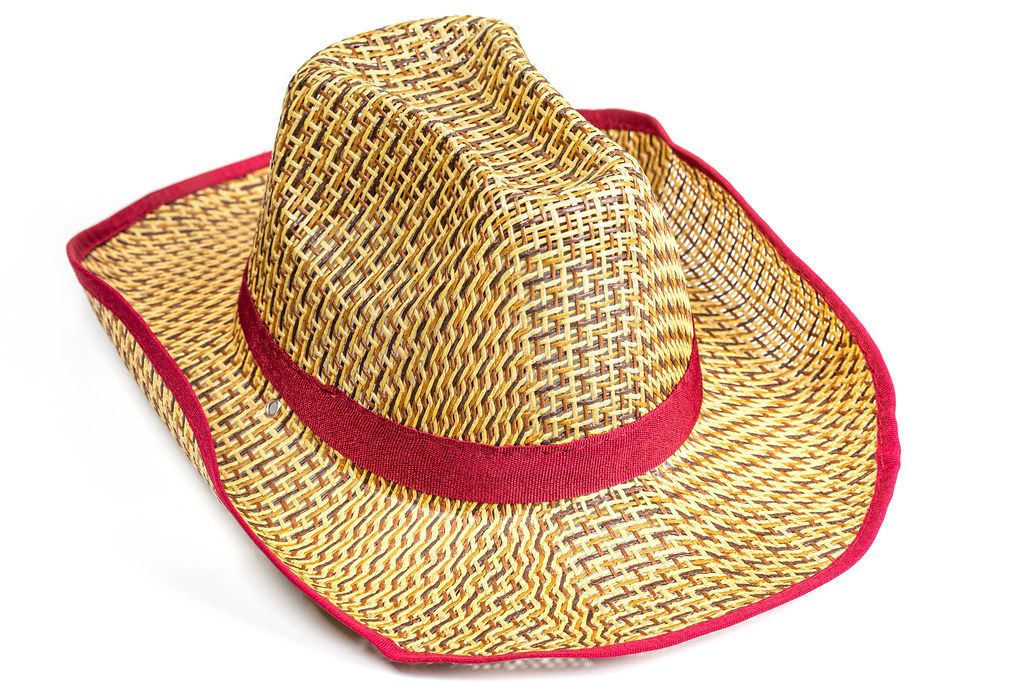 Yellow wicker straw hat on white background