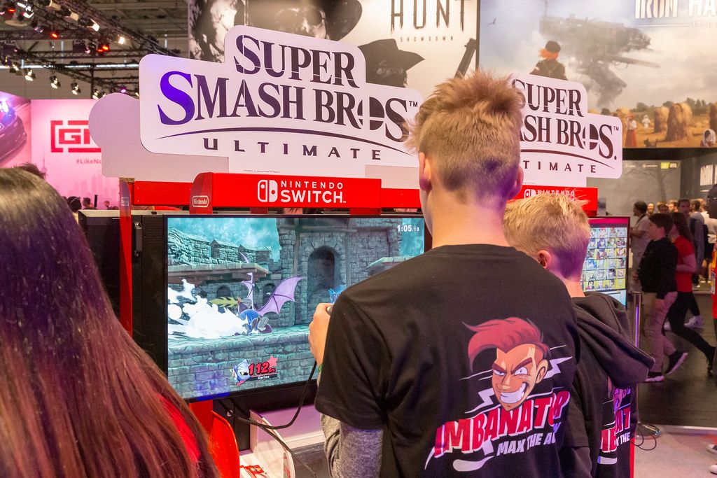 Young Gamescom visitors play the video game Super Smash Bros Ultimate on the Nintendo Switch