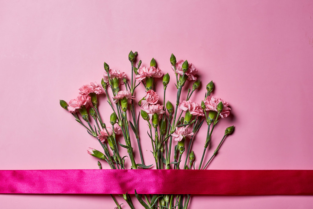 14. Fresh flowers bunch and ribbon on pink background.jpg