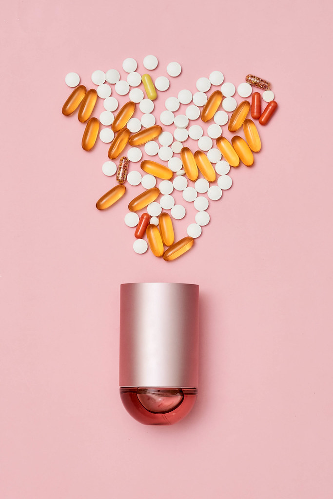 30. Pile of medical drugs and container on bright color background