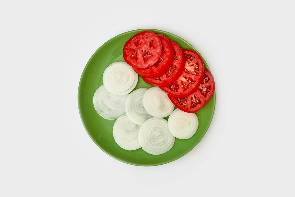 A bowl of sliced tomatoes and onions