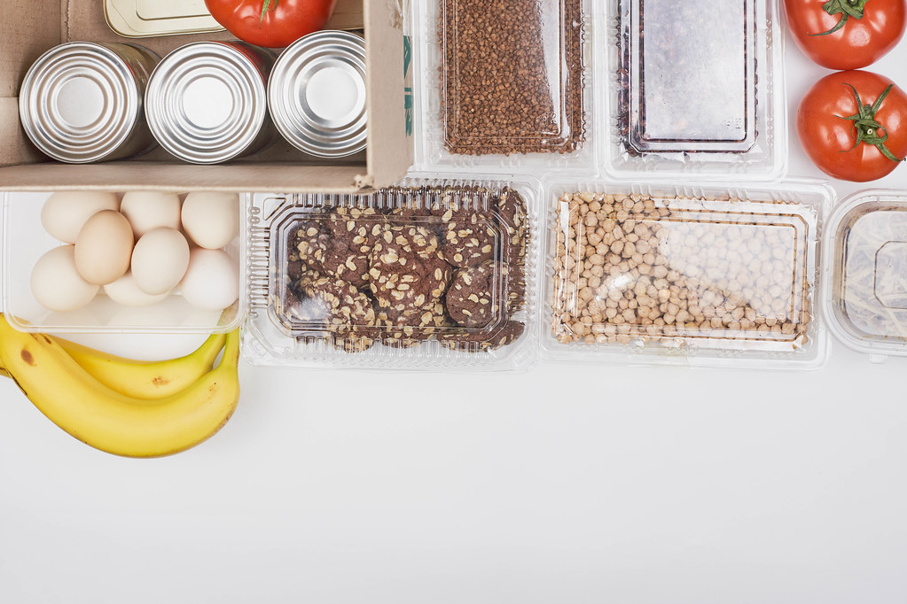 A box for those in need: bananas, eggs, cookies, nuts, tomatoes and tin cans from a food bank