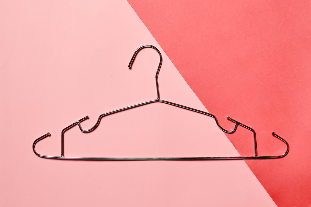 A cloth hanger on bright colorful background