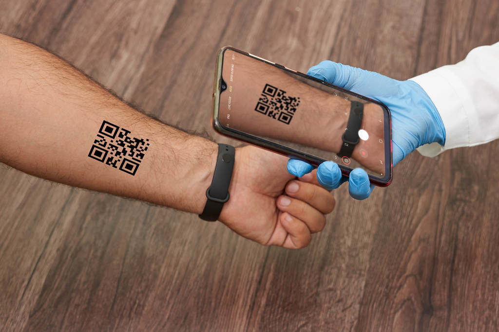 A doctor checking COVID vaccination QR code