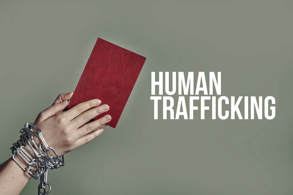 A female hands in chains holding passport - human trafficking
