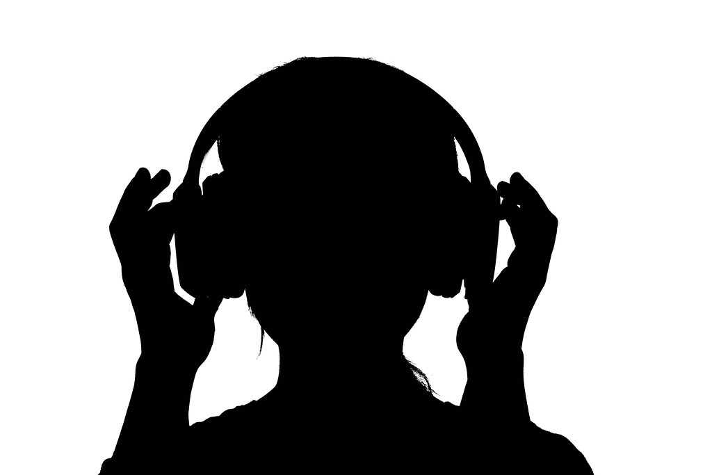A female silhouette with wireless headphones set