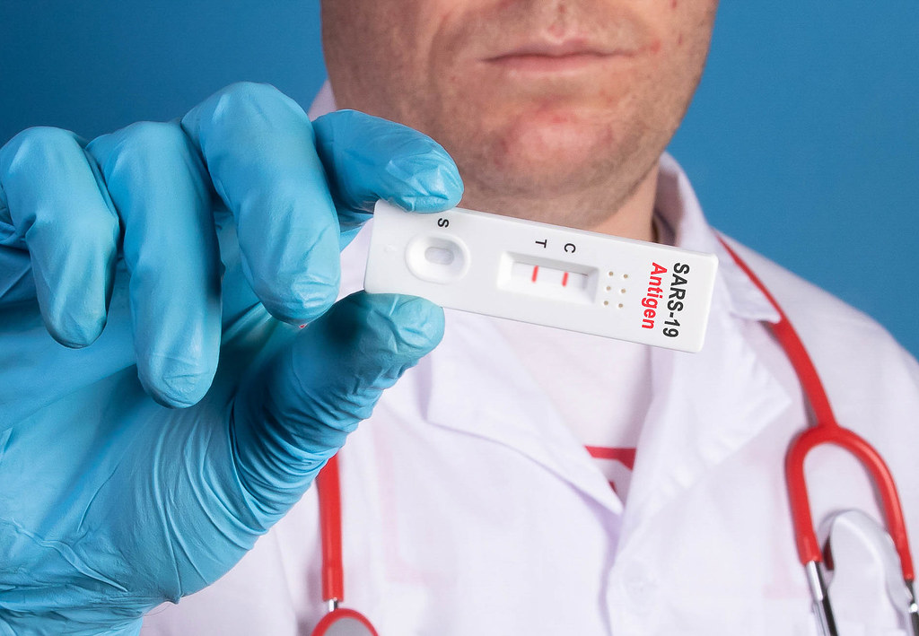 A healthcare professional holds covid-19 ag test