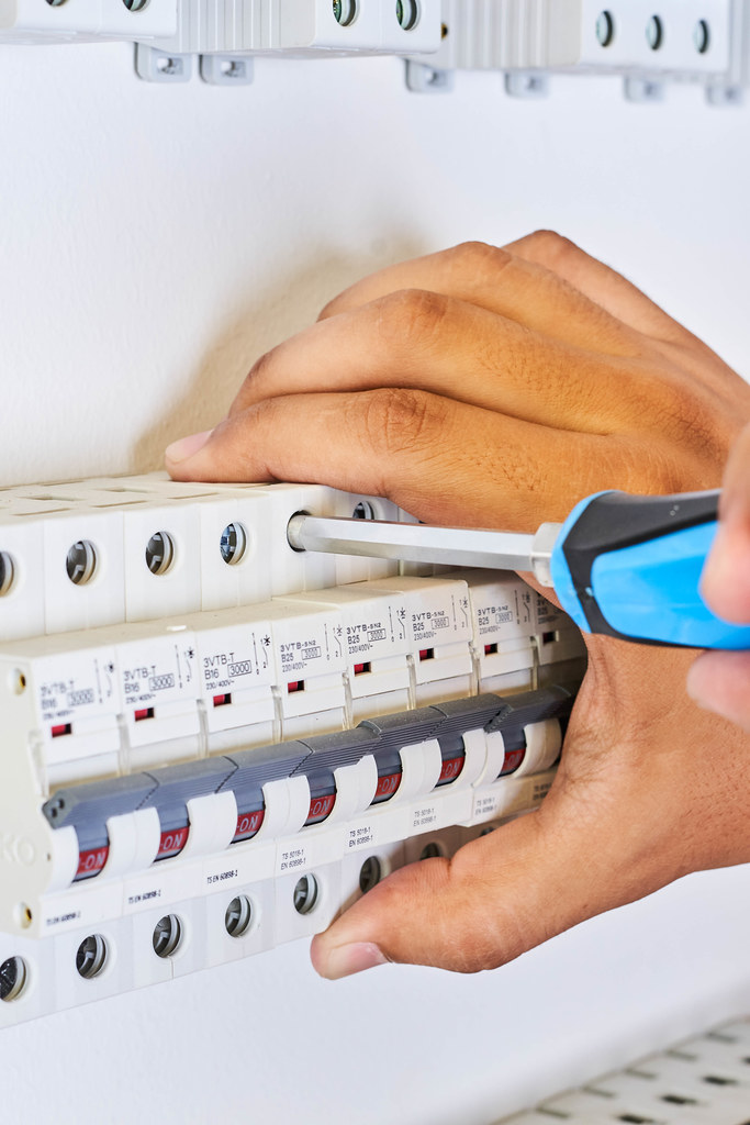 A man installing Automatic circuit breakers