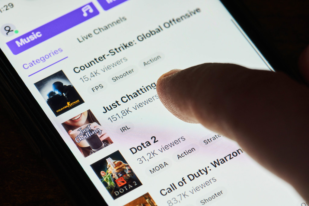 A person browsing Twitch video streaming service app on mobile phone