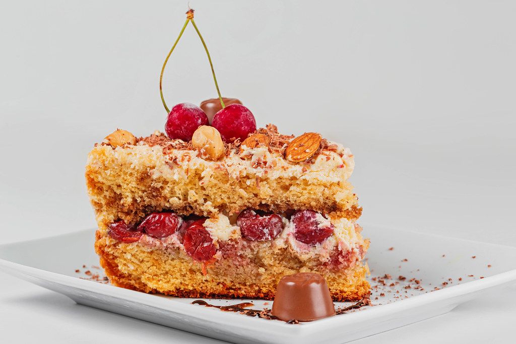 A piece of delicious cherry cake with nuts