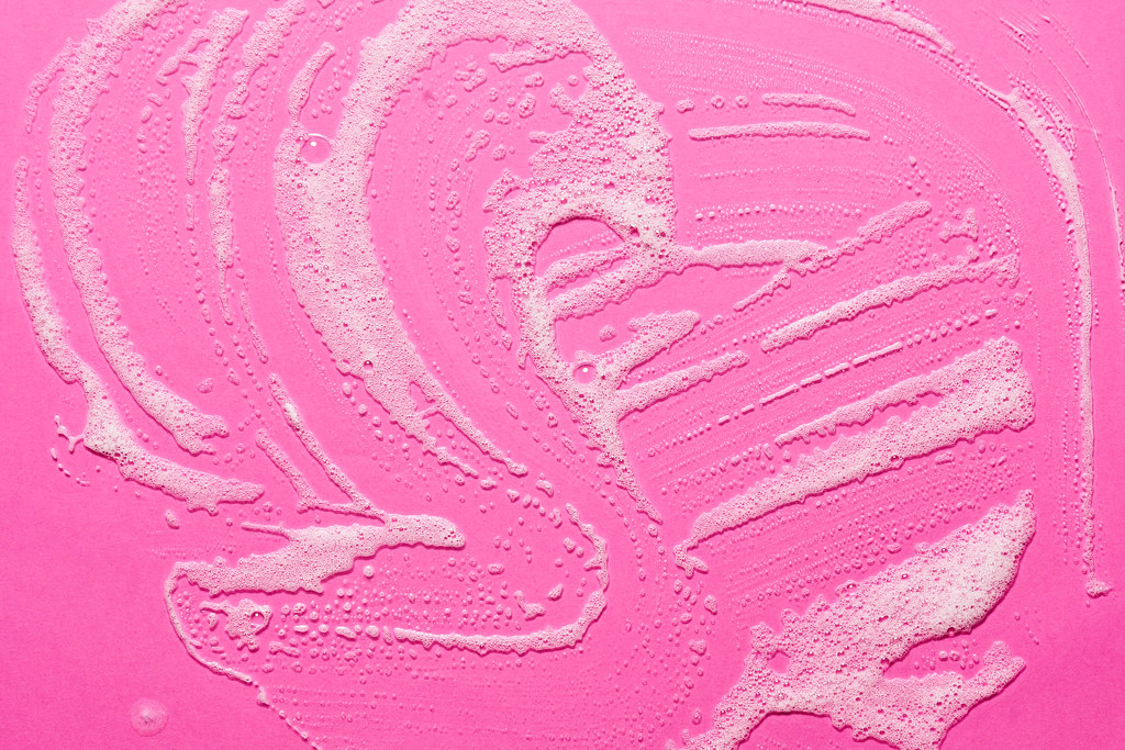 A pink surface with foam