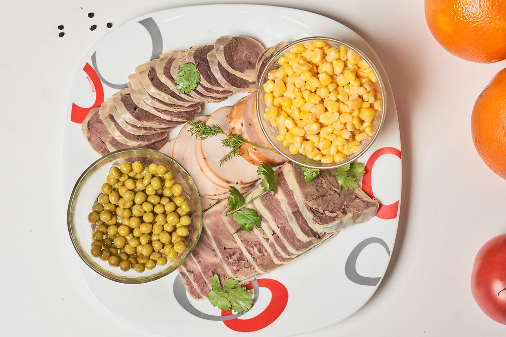 A plate of different sliced smoked meat products