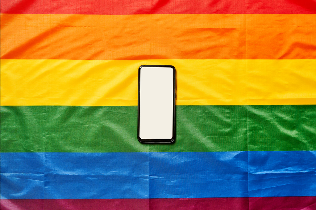 A smartphone with blank screen on rainbow lgbt flag