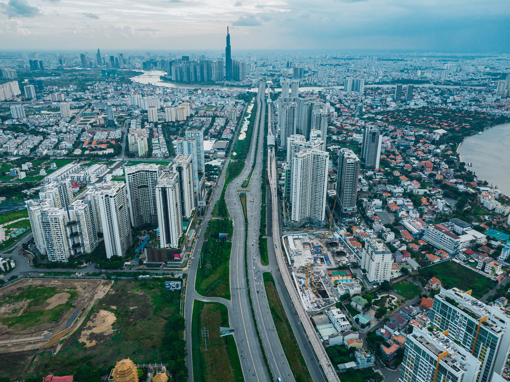 Aerial Drone Photo of Ho Chi Minh City, Vietnam with many Apartment Buildings, Construction Sites, Skyscrapers and the Saigon Metro Line