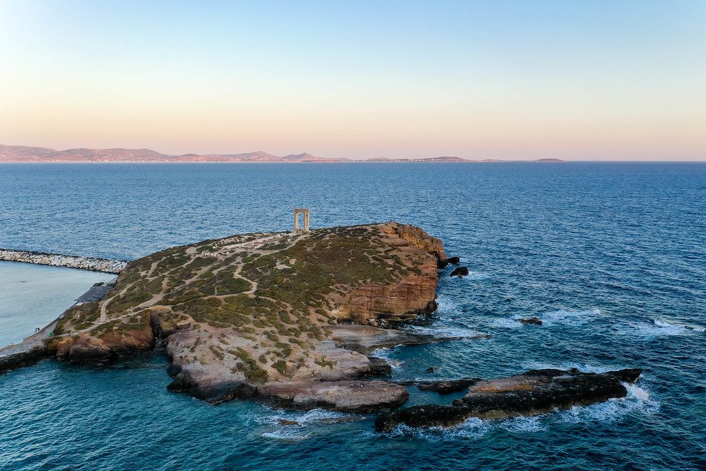 Aerial shot: the islet of Palátia, at the entrance to Naxos harbour, with the Portara, symbol of the island