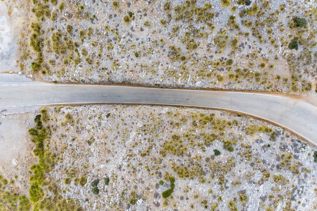 Aerial view of empty road in the middle of scanty vegetation. Carretera de Sa Calobra on Majorca