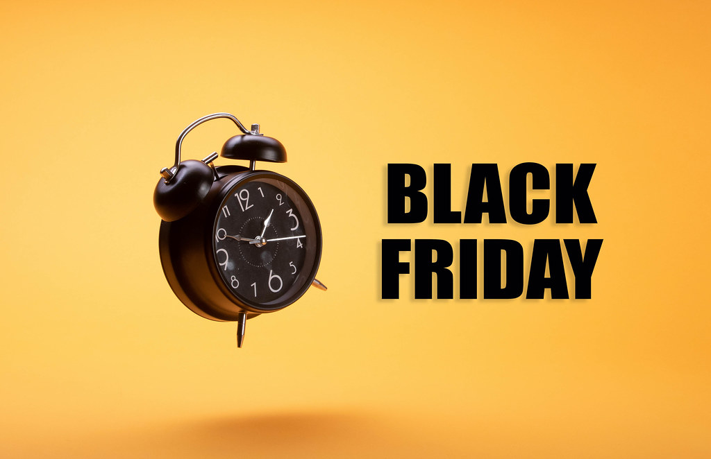Alarm clock with Black Friday text on orange background