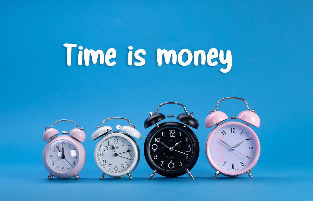 Alarm clocks with Time is Money text on blue background