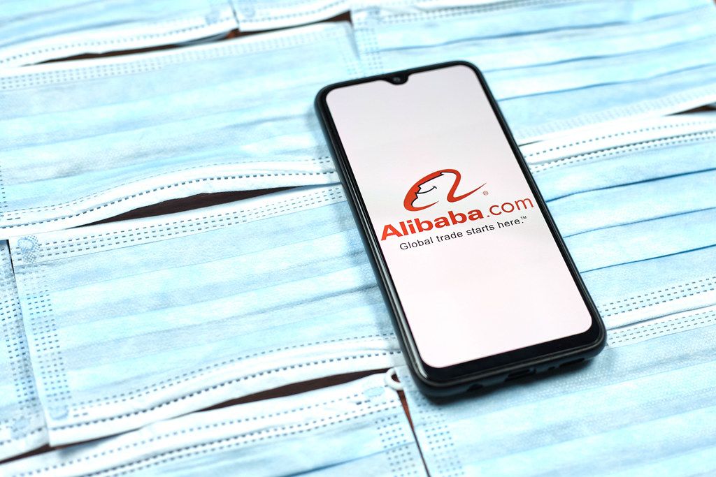 Alibaba - chinese company logo on mobile phone screen. Coronavirus crisis changing global business rules