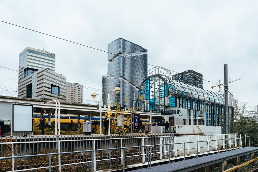 Amsterdam-Zuid train station with modern glass high-rise buildings in the background