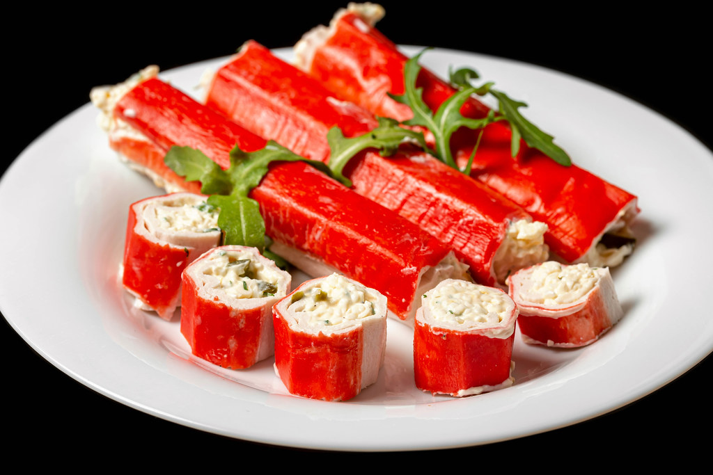 Appetizer with crab sticks, cheese, eggs and herbs