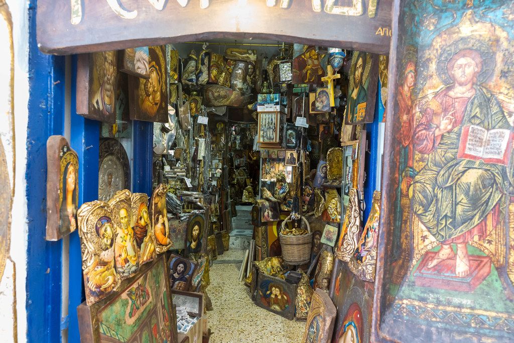Art shop packed with all sorts of Christian paintings on the island of Mykonos, Greece