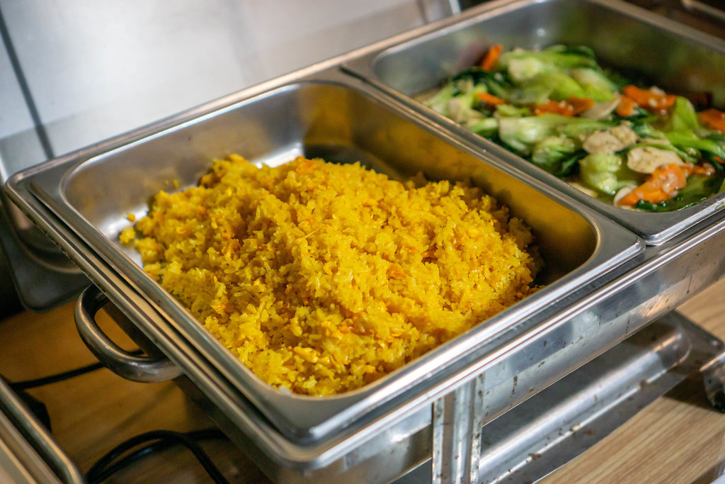 Asian Fried Rice and Stir Fried Vegetables in a Food Warmer at a Buffet inside a Restaurant