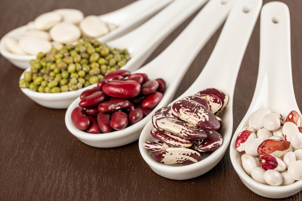Assortment of beans in spoon, close up