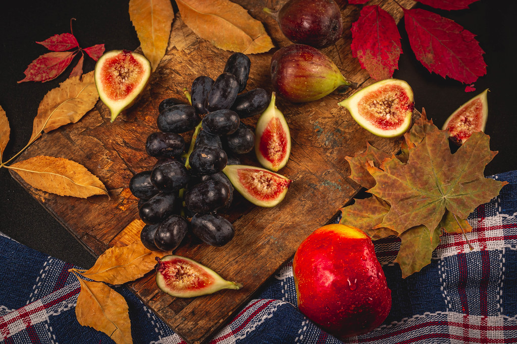 Autumn background with dry leaves and fresh fruit