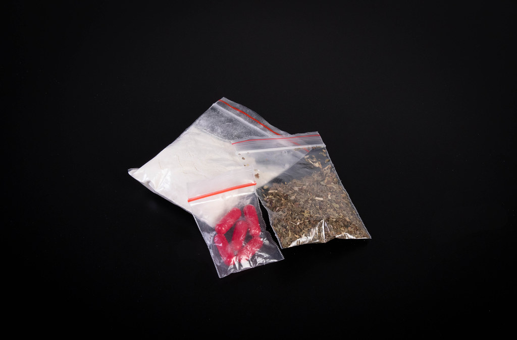 Bags with drugs on dark background