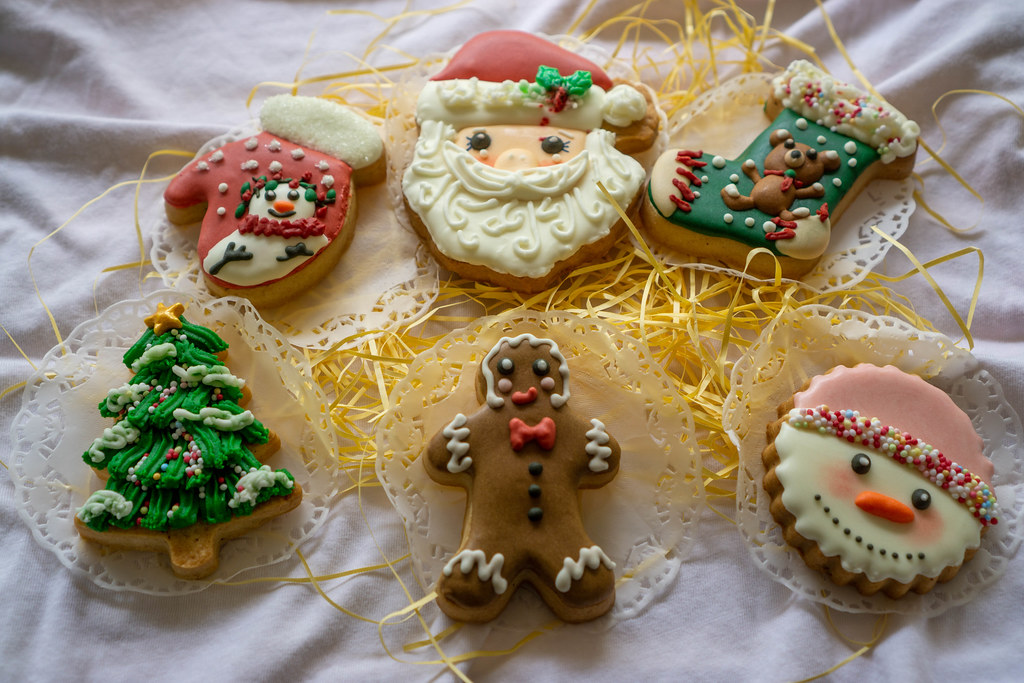 Baked Gingerbread Christmas Cookies in Different Designs such as Christmas Tree, Gingerbread and Santa Claus decorated with Icing
