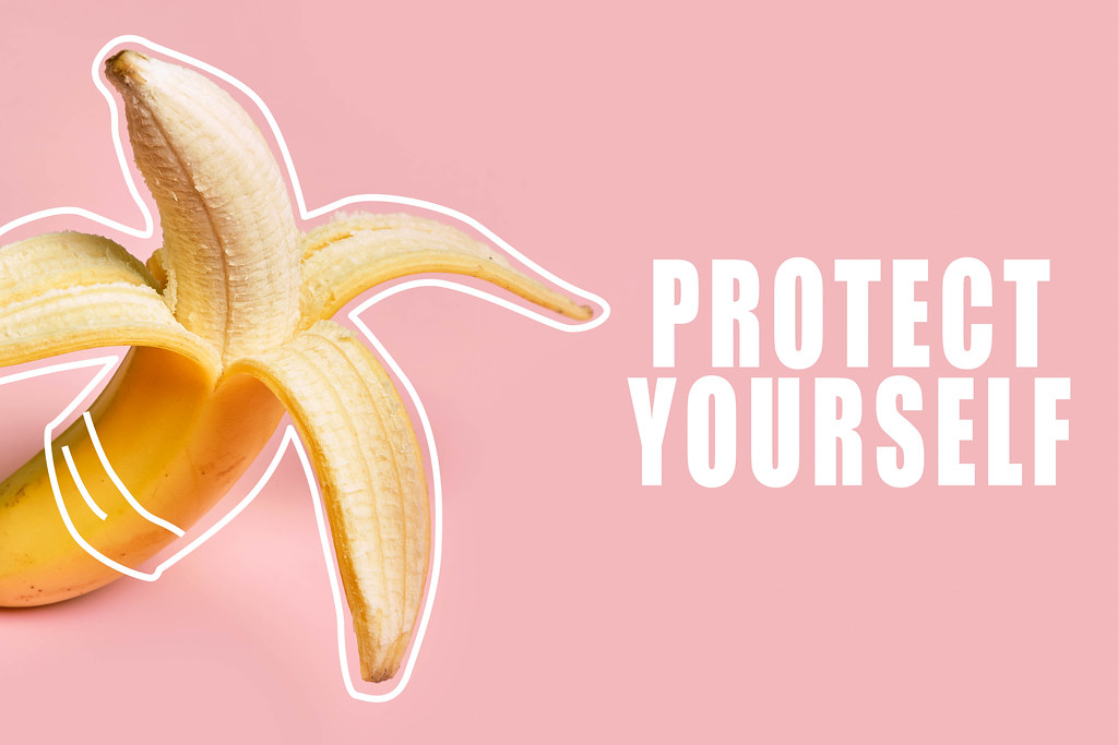 Banana covered with drawn condom - protect yourself. Sexual health concept